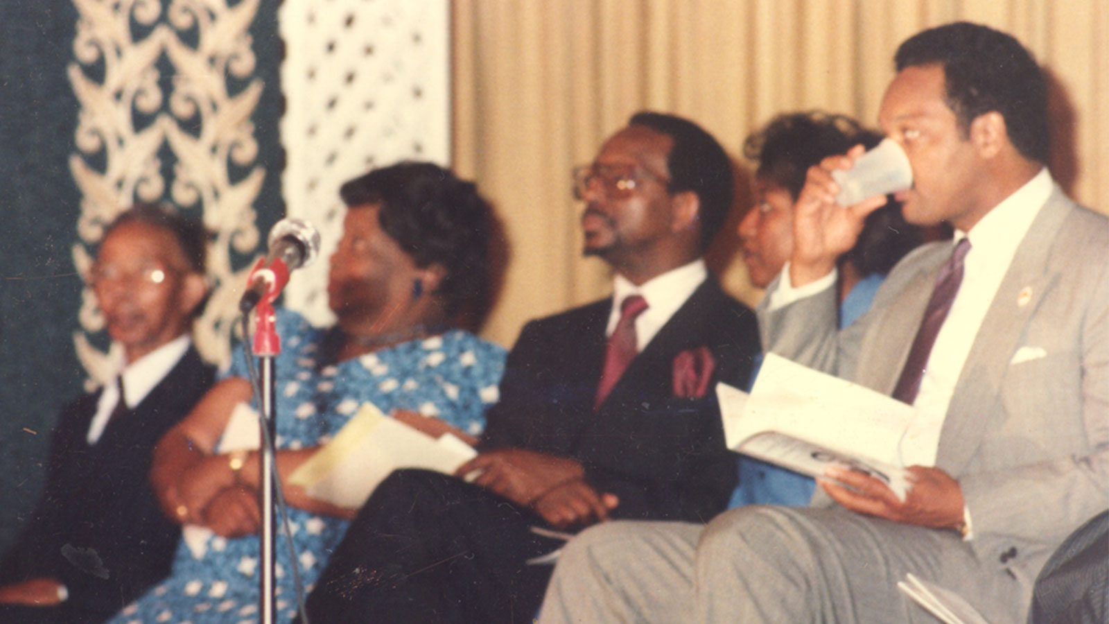 Rev. Jesse L. Jackson seated with Ron Daniels’ family before speaking at a testimonial event.