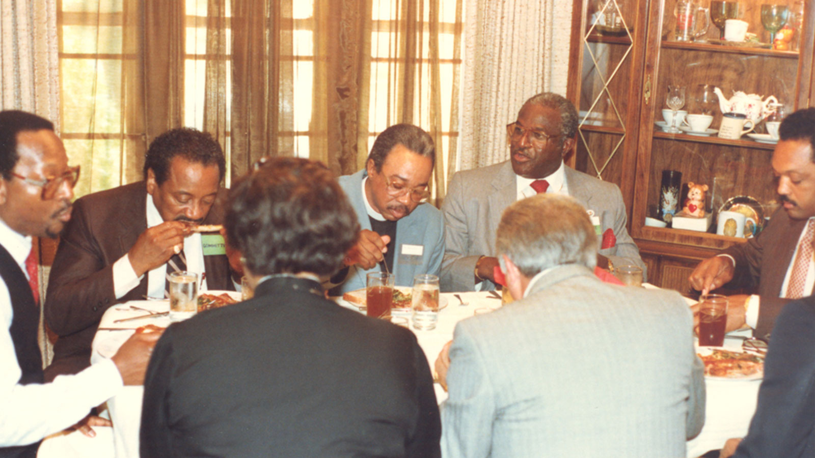 Rev. Jesse L. Jackson shares a meal with Ron Daniels and guests at the Daniels family home.