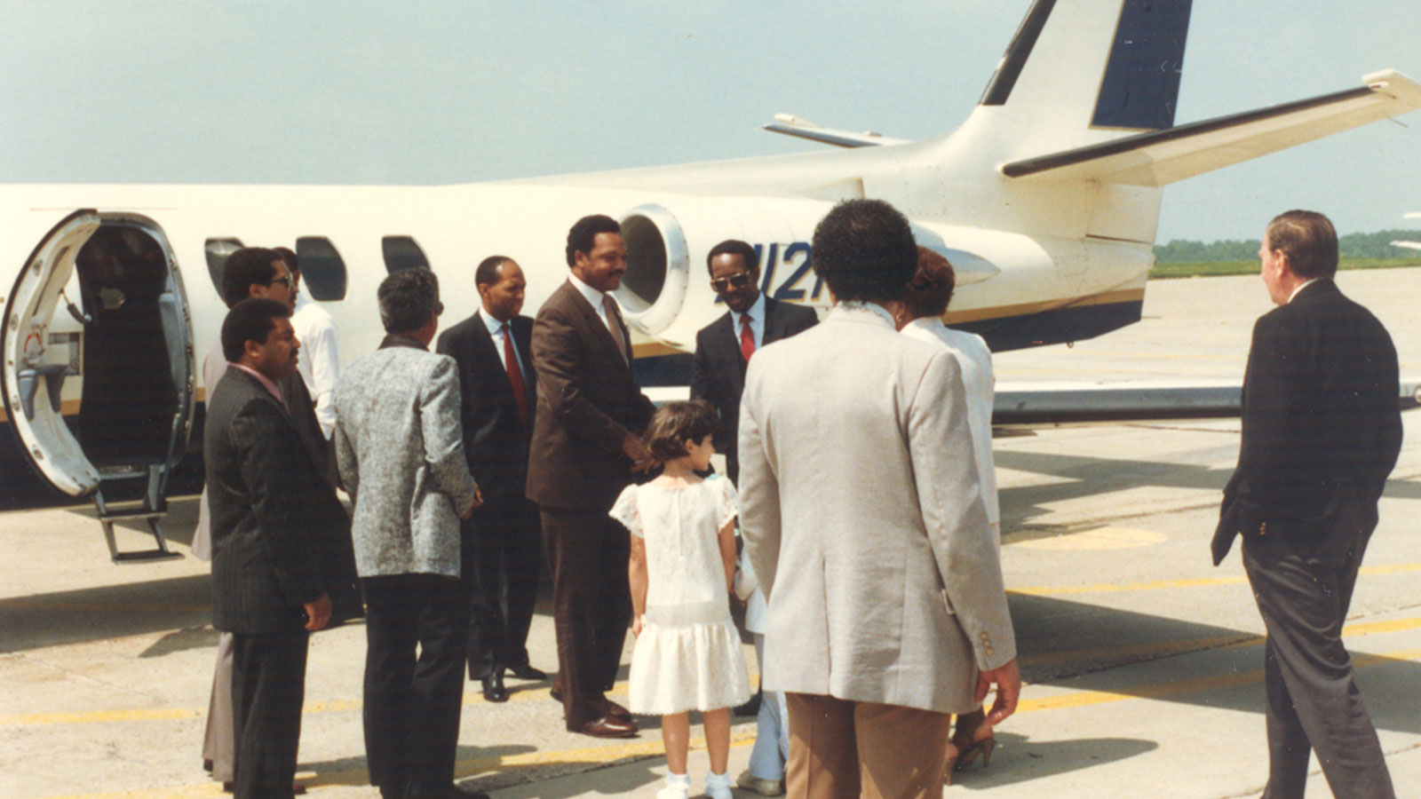 Children gathered at Youngstown Municipal Airport preparing to greet Rev. Jesse L. Jackson during his arrival.