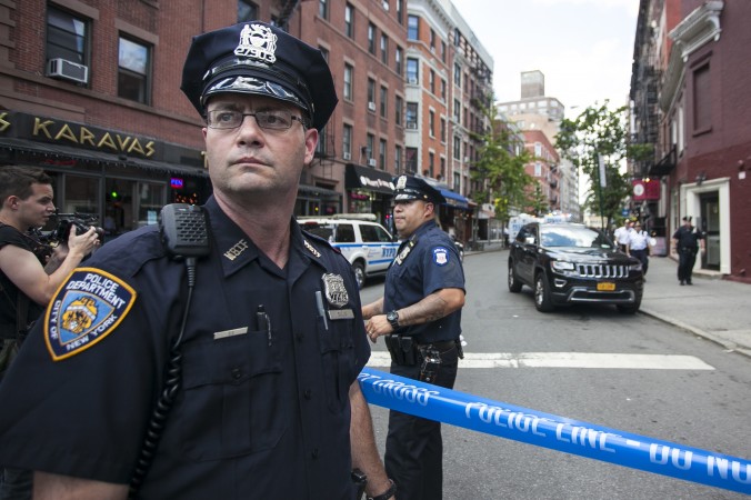 Police officers next to a crime scene in the West Village, Manhattan, N.Y., on July 28, 2014. (Samira Bouaou/Epoch Times)