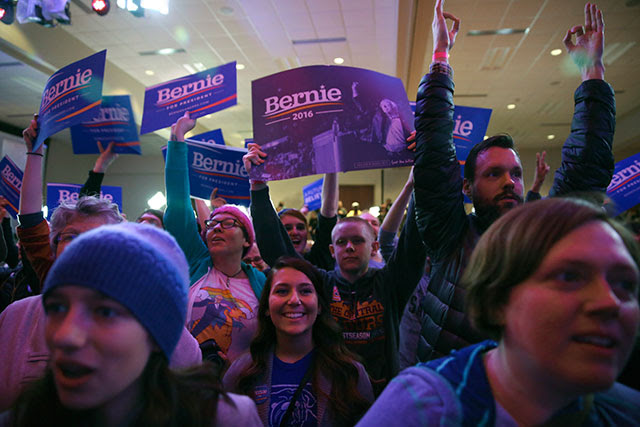 Supporters of Sen. Bernie Sanders watch election returns in a caucus night event for Sanders in Des Moines, Iowa, Feb. 1, 2016. (Photo: Todd Heisler / The New York Times)