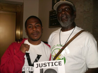 Baba Jahahara came to court to support JR Valrey, who had been jailed a few days after the murder of Oscar Grant immediately asking Mayor Ron Dellums at a press conference why he had taken no action against the killer cop. JR had to fight the ridiculous charge of setting fire to a trash can for the ensuing year.
