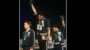 Tommie Smith, center, and John Carlos raise their fists during "The Star-Sp