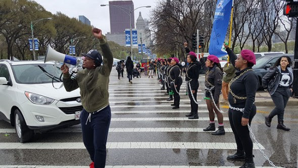 An organizer with Fearless Leading by the Youth leads chants as the blockade line forms and traffic comes to a halt. (Photo: Kelly Hayes)