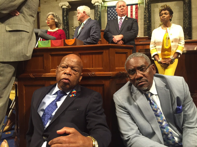 Rep. John Lewis sits next to Rep. Gregory Meeks on the floor of the House of Representatives in Washington, D.C.,  on June 22, 2016.