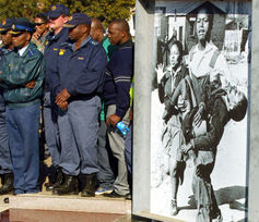 Policemen stand in front of the Hector Pieterson memorial during the 30th anniversary of the Soweto Uprising. Reuters/Siphiwe Sibeko