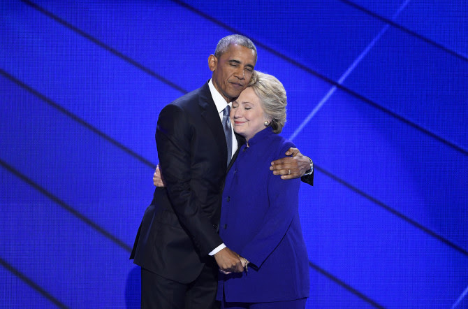 President Barack Obama hugs Hillary Clinton, the 2016 Democratic presidential nominee, onstage during the Democratic National Convention in Philadelphia July 27, 2016.