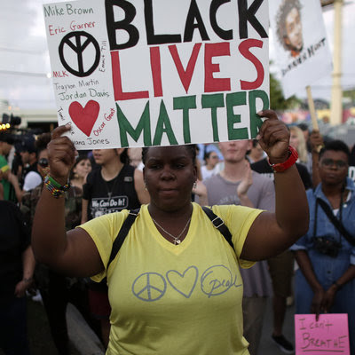 Desiree Griffiths of Miami holds up a sign reading "Black Lives Matter" during a protest over the deaths of Michael Brown and Eric Garner.