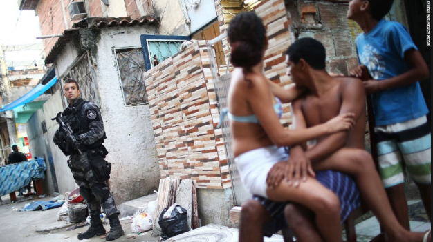 A Brazilian military police officer patrols after entering the unpacified Complexo da Mare, one of the largest favela complexes in Rio de Janeiro, on March 30, 2014.