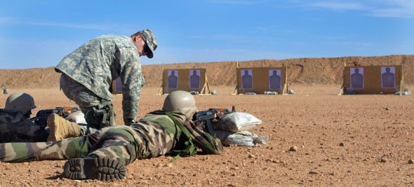 A U.S. Army trainer coaches a Republic of Niger soldier on marksmanship techniques at an AK-47 qualification range near Agadez, Niger. Photo: Spc. Craig Philbrick/U.S. Army Africa