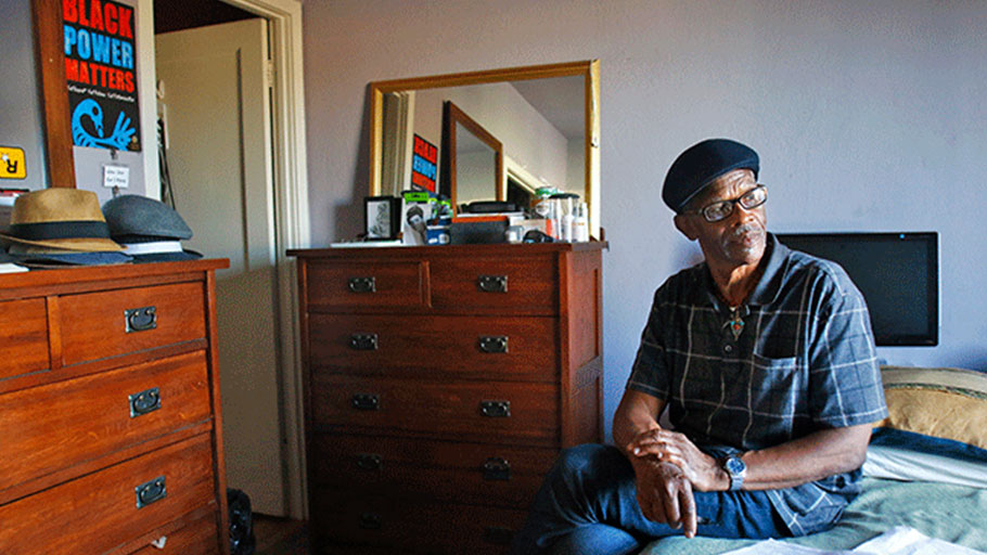 Watani Stiner sits in his room at the restorative justice-centered house Sister Water, at Canticle Farm in the Fruitvale District in Oakland, Calif. Stiner, a former member of the Black nationalist group US, was sentenced to life in prison following the 1969 shootout at UCLA, in which two members of the Black Panther Party were shot and killed as activist groups called for the founding of a Black studies program at the university. Now, after being released, Stiner leads monthly speaking engagements at high schools, colleges, and organizations centered on criminal justice. Living at Sister Water, he says, has helped him discover his passion for speaking and makes his “journey worthwhile.”