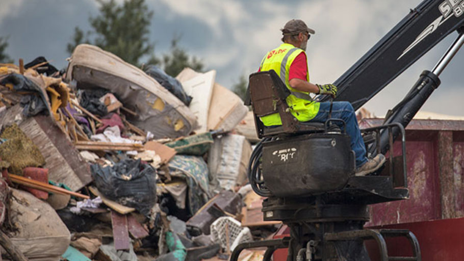 A worker, not wearing protective gear, at the temporary dumpsite on 19th Street in Port Arthur, Texas.