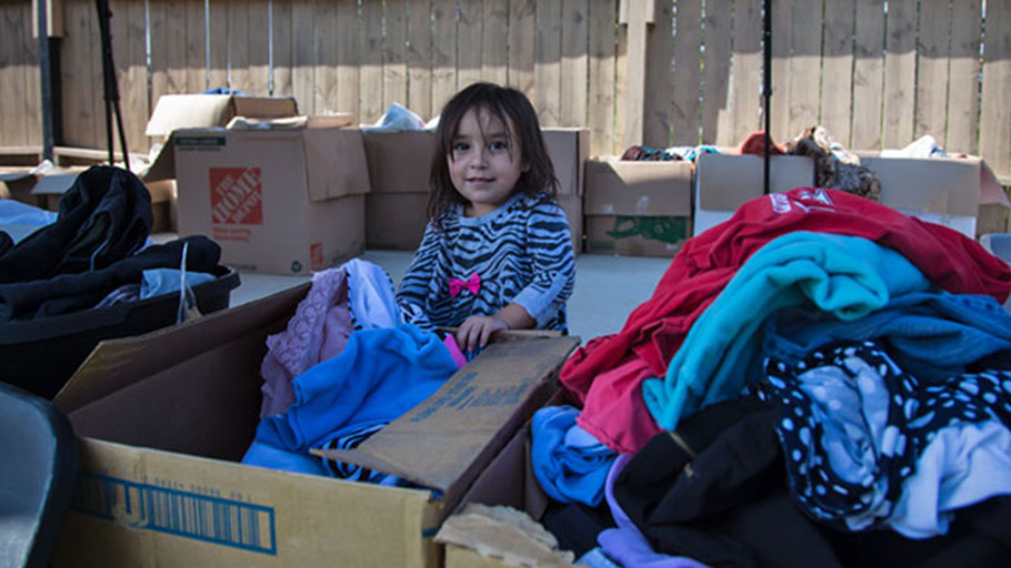 A young storm victim gathers donated supplies at a makeshift relief center in the driveway of Kelley's Kitchen.