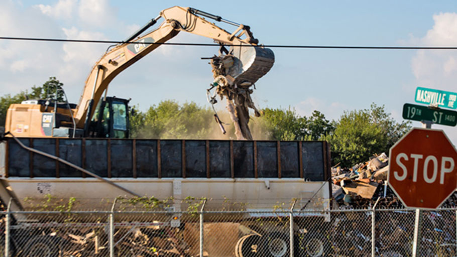 Dust in the air as debris at a temporary dumpsite on 19th Street in Port Arthur, Texas, is sorted.