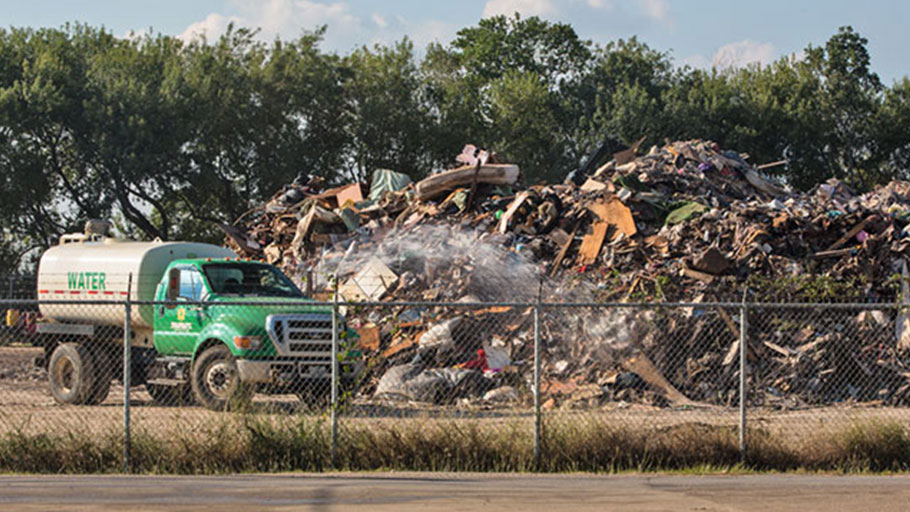 Truck spraying water to mitigate dust particles in the air at a temporary dumpsite on 19th Street in Port Arthur, Texas.