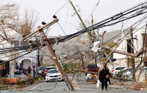 Residents of St. Croix make their way around and under obstacles blocking a main road nearly a week after Hurricane Maria raked the US Virgin Islands.