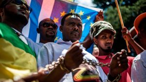 Members of the Africa Diaspora Forum (ADF), civil society organisations, churches, trade unions and other coalitions wear chains and shout slogans during a demonstration against the slave trade and human trafficking in Libya on December 12, 2017, at the Union Buildings in Pretoria