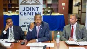 Elroy Sailor of Insight America and Spencer Overton of the Joint Center for Political and Economic Studies listen to now HUD Secretary Ben Carson on a panel. Insight America and the Joint Center worked together to in attempt to get bi-partisan resumes of African-Americans to the Trump Administration. Sources said most were blocked.