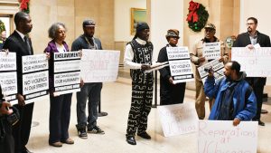 PROTESTORS AT CITY HALL demand reparations from the University of Chicago, which profited from the sale of land donated by slaveowner Stephen A. Douglas. (Photo by Robert Earl) By Patrick Forrest, Chicago Crusader