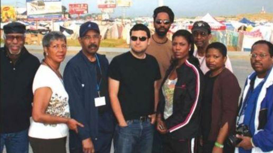 Omarosa (fifth from left) among this media delegation in Haiti, was a celebrity ambassador for IBW's Haiti Support Project in 2010. IBW President Ron Daniels, in cap behind her, says she has since rejected his advice to her about President Trump.