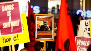 People attend an Anti-Trump demonstration to protest U.S. President's coming to the World Economic Forum of Davos, in Geneva.