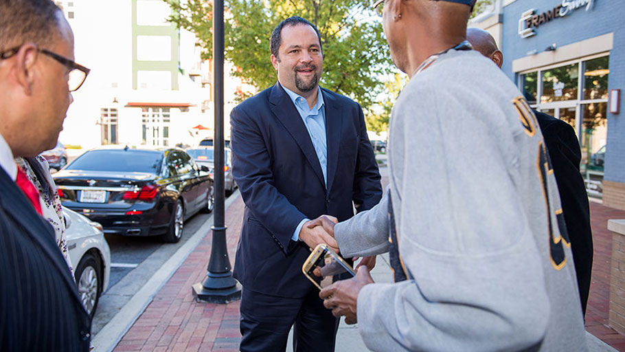 Ben Jealous shakes hands with admirers outside a restaurant moments before declaring his endorsements from Sens. Bernie Sanders and Cory Booker.