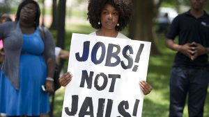 A demonstrator holds a sign during a 2013 rally following a protest march calling on former President Barack Obama to end the so-called War on Drugs.