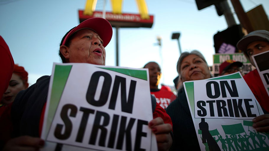 People participate in a Fight for $15 wage protest in Los Angeles, California
