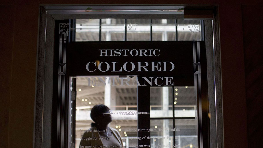 Woman stands in the doorway of then new Historic Colored Entrance at the Lyric Theatre, in Birmingham, Ala