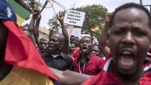 Demonstrators carry banners as they march during a protest in Ghana's capital Accra, March 28, 2018