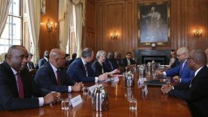 Britain's Prime Minister Theresa May, centre left, hosts a meeting with leaders and representatives of Caribbean countries, inside 10 Downing Street in central London, Tuesday April 17, 2017, on the sidelines of the Commonwealth Heads of Government meeting (CHOGM). May met with Caribbean leaders and envoys Tuesday, and told them "we are genuinely sorry for any anxiety that has been caused" personally apologizing for the treatment of long-term U.K. residents from the Caribbean who have been asked to prove their right to stay in the country.