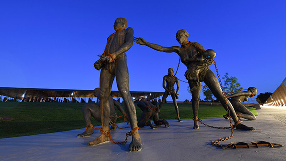 A sculpture by artist Kwame Akoto-Bamfo, part of the Nkyinkyim Installation, of enslaved people in chains is shown after entering The National Memorial for Peace and Justice on April 20, 2018, in Montgomery, Al.