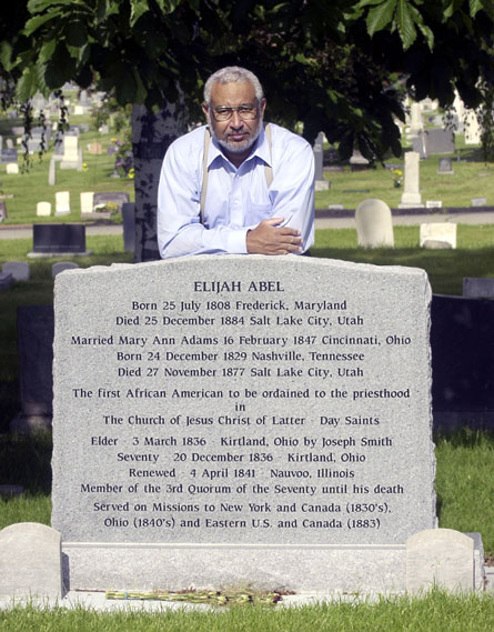 Darius Gray, a contemporary Mormon African-American leader at the tombstone of Elijah Abel.