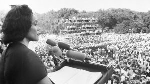Coretta Scott King addressing a Poor People’s Campaign rally from the steps of the Lincoln Memorial on June 19, 1968. She told the nearly 50,000-strong crowd that “racism, poverty and war” combined to make matters worse for poor black and white people alike.