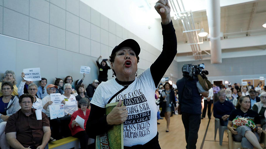 A woman protests at a town-hall meeting being held by Thomas Homan, acting director of enforcement for ICE, in Sacramento, California, March 28, 2017.