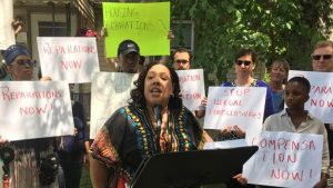 Sonja Bonnett and other members of the Coalition to End Unconstitutional Tax Foreclosures in front of Bonnett's new Detroit home, which the group acquired for her.