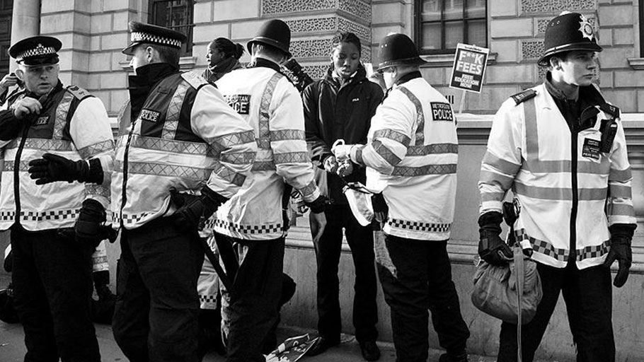 Black student handcuffed by the Metropolitan Police during student protests in London, 2010 (Photo: Chris Beckett, Flickr).