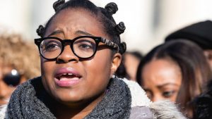 Charlene Carruthers, founding national director of the Black Youth Project 100, speaks at a news conference at the U.S. Capitol on March 15, 2018.