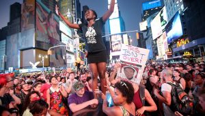 Trayvon Martin supporters rally in Times Square while blocking traffic after marching from a rally for Martin in Union Square in New York, on July 14, 2013. George Zimmerman was acquitted of all charges in the shooting death of Martin on July 13, 2013. Many protesters challenged the verdict.