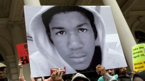 People attend a press conference along with New York City Council members to call for justice in the February 26, 2012, killing of 17-year-old Trayvon Martin in Sanford, Florida, on the steps of City Hall, in New York, on March 28, 2012.