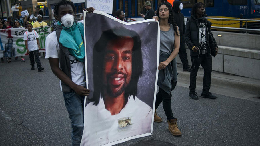 Protestors carry a portrait of Philando Castile on June 16, 2017, in St. Paul, Minnesota. Protests erupted in Minnesota after Officer Jeronimo Yanez was acquitted on all counts in the shooting death of Castile. STEPHEN MATUREN/GETTY