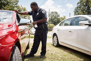 A Ville Platte Police Department officer, Lucas Griffin, talks with a motorist involved in a minor accident.