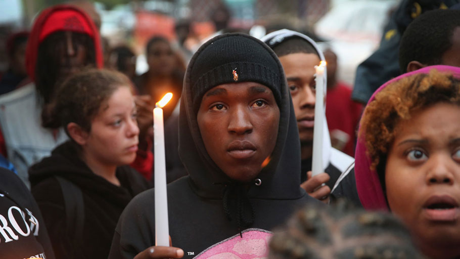 Mourners attend a candlelight vigil in memory of 18-year-old Vonderrit Myers Jr. on October 9, 2014, in St. Louis, Missouri. Meyers was shot and killed by an off-duty St. Louis police officer.