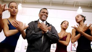 Arthur Mitchell as artistic director of Dance Theatre of Harlem, with dancers after a class in 2003.