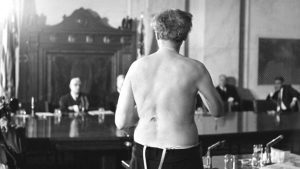 Rev. Richard Wurmbrand stands stripped to the waist to show scars of torture, as he testifies to the Senate Internal Security Subcommittee.