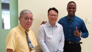 Elder William Allum Poon, an unidentified Chinese congregation member, and Pastor Brian Rochester of the Grace Chapel church, Port of Spain, Trinidad and Tobago.