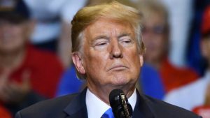 President Donald Trump with a serious look as he delivers a speech at a campaign rally held at the Mohegan Sun Arena.