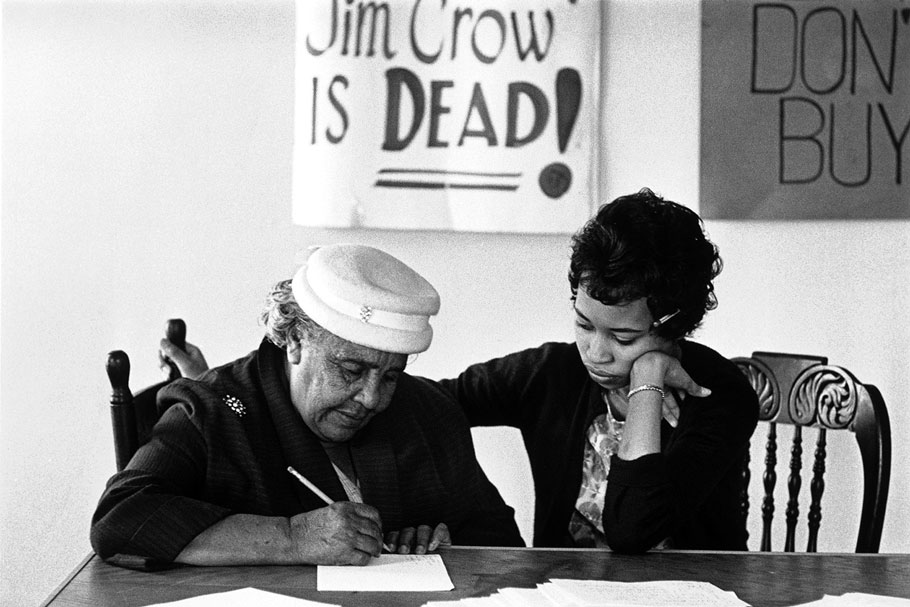 A civil rights activist teaching a woman to write in order to be able to vote, Petersburg, Virginia, 1960