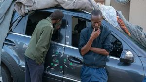 Mr. Magaqa’s cousin Ntlantla Dlamini, right, with the politician’s bullet riddled car.