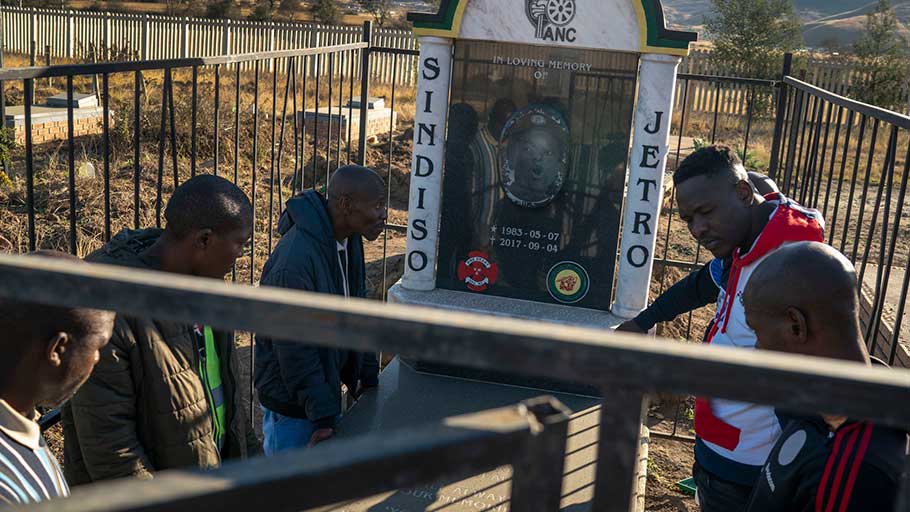 Mr. Dlamini, center, and friends, including members of a soccer team formed by Mr. Magaqa, visiting the politician’s grave in Ibisi.
